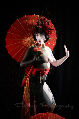 Body painted woman with red umbrella